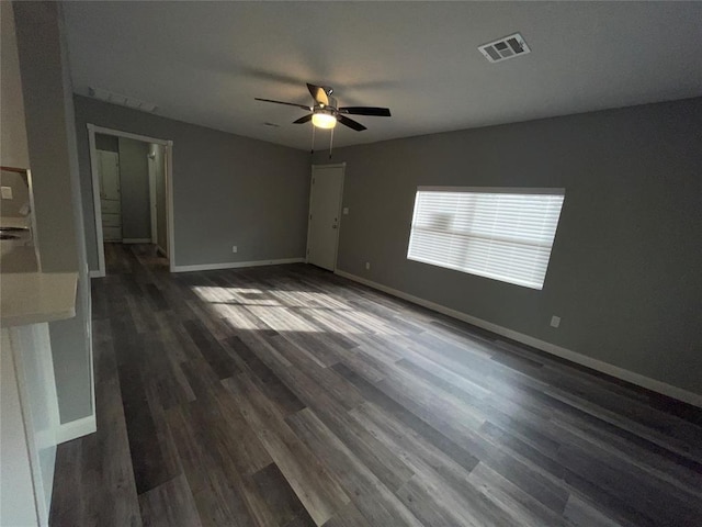 interior space featuring dark wood-type flooring and ceiling fan