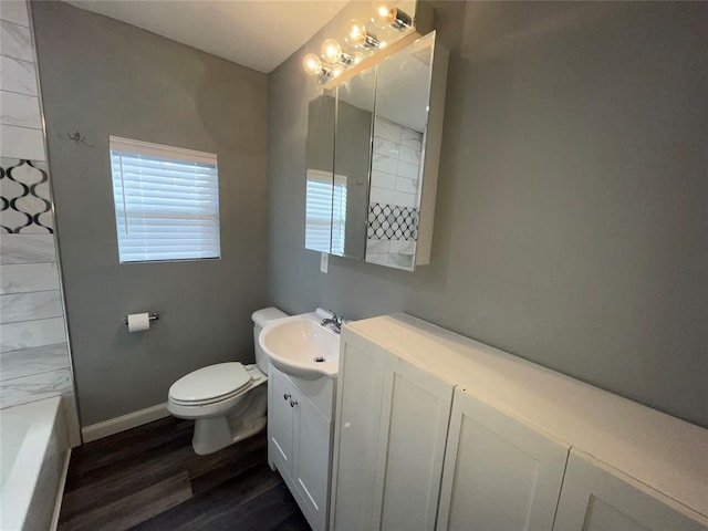 full bathroom with hardwood / wood-style flooring, shower / tub combination, vanity, and toilet