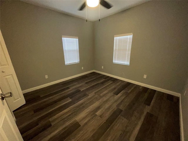 empty room with dark hardwood / wood-style floors and ceiling fan