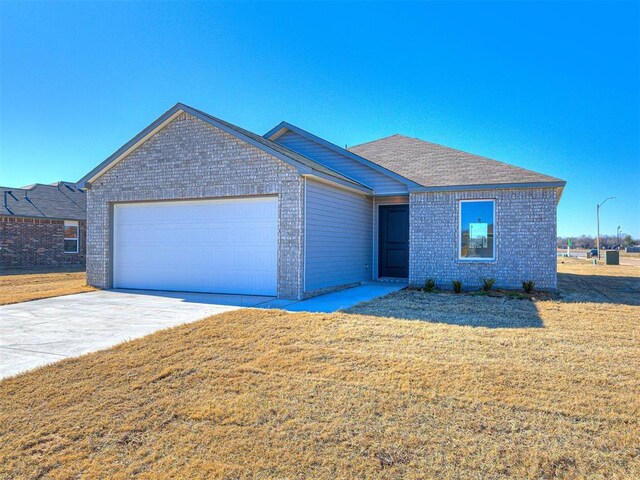 view of front of property with a garage and a front yard