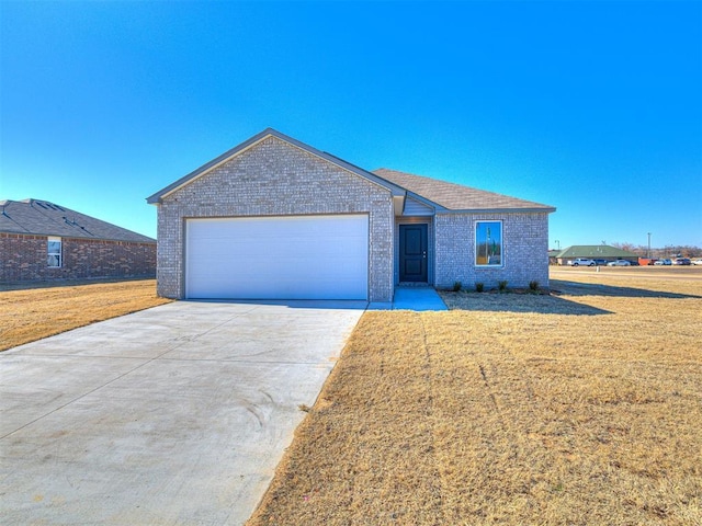 view of front of home with a garage and a front lawn