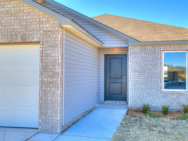 doorway to property featuring a garage