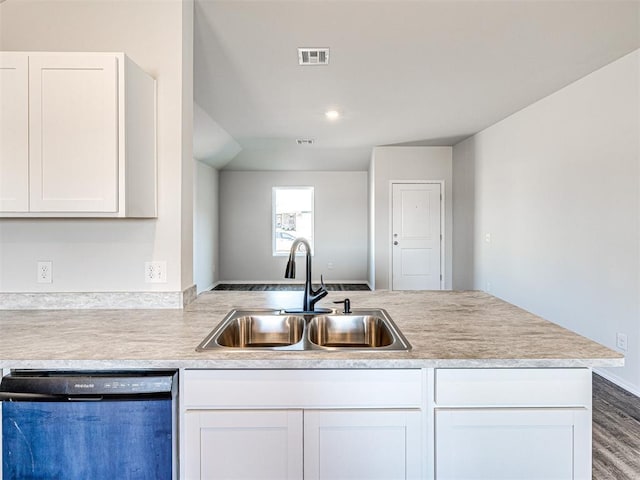 kitchen with black dishwasher, sink, kitchen peninsula, and white cabinets