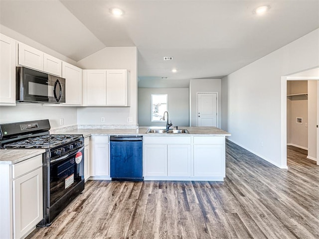 kitchen featuring white cabinetry, kitchen peninsula, sink, and black appliances