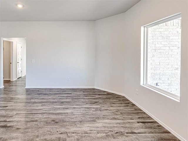 spare room with dark hardwood / wood-style floors