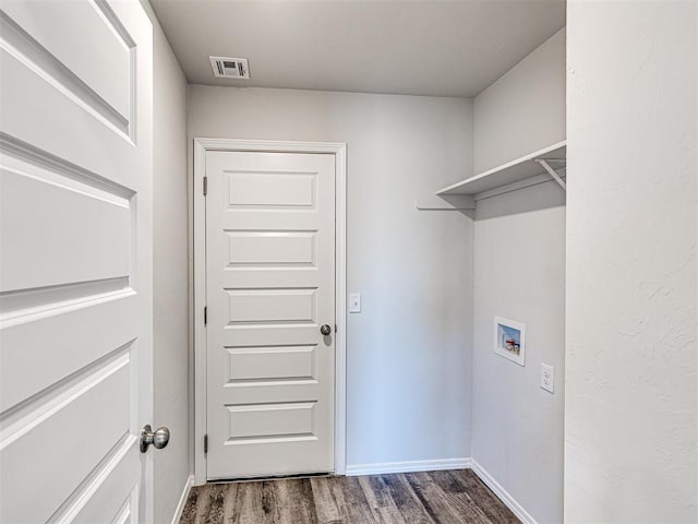 laundry room featuring dark hardwood / wood-style floors and hookup for a washing machine