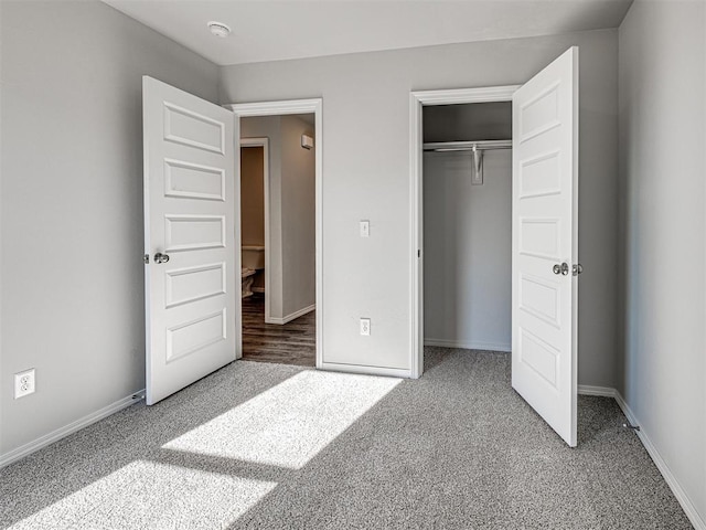 unfurnished bedroom featuring carpet and a closet