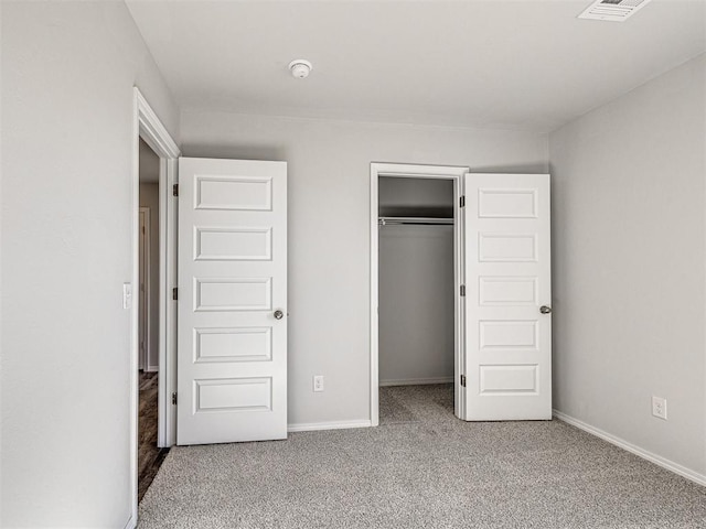 unfurnished bedroom featuring carpet floors and a closet