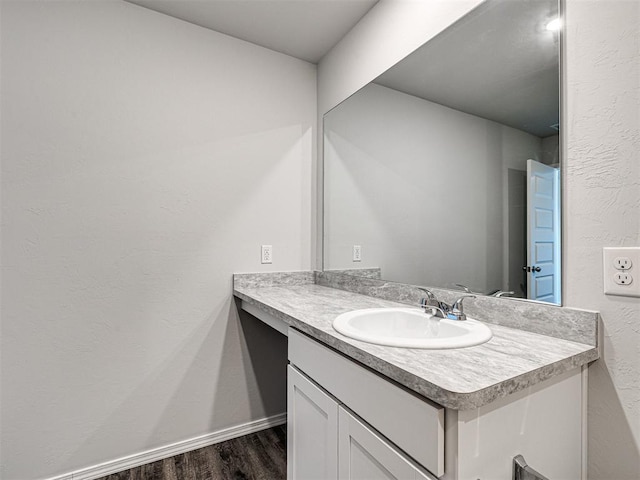 bathroom with vanity and hardwood / wood-style floors