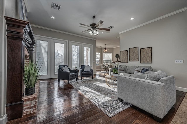 living room featuring hardwood / wood-style floors, crown molding, french doors, and ceiling fan