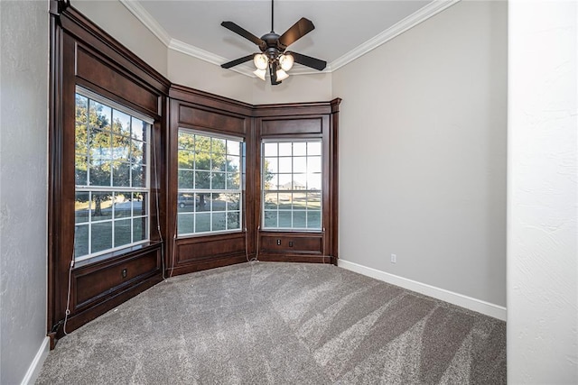 spare room with ceiling fan, ornamental molding, and carpet flooring