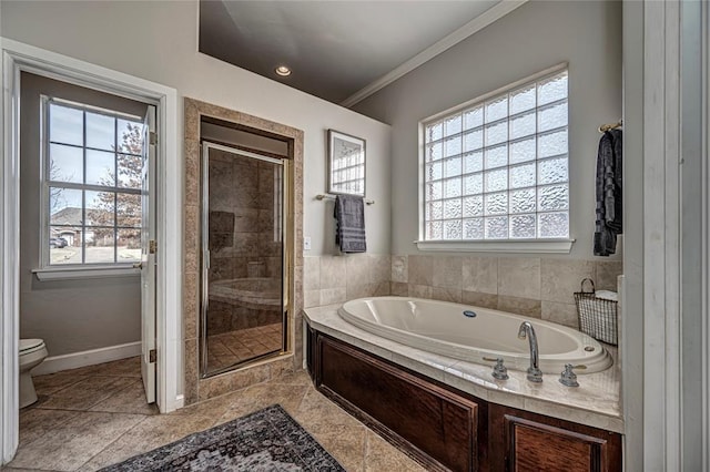 bathroom with a healthy amount of sunlight, toilet, and separate shower and tub