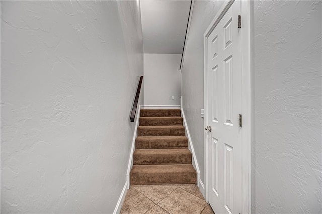 stairs featuring tile patterned flooring