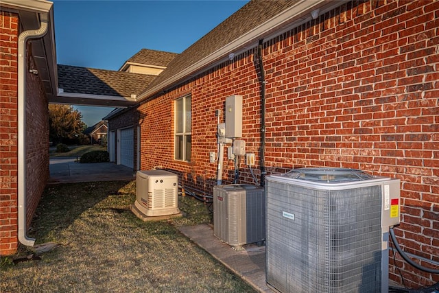 view of side of home featuring a garage and central AC unit