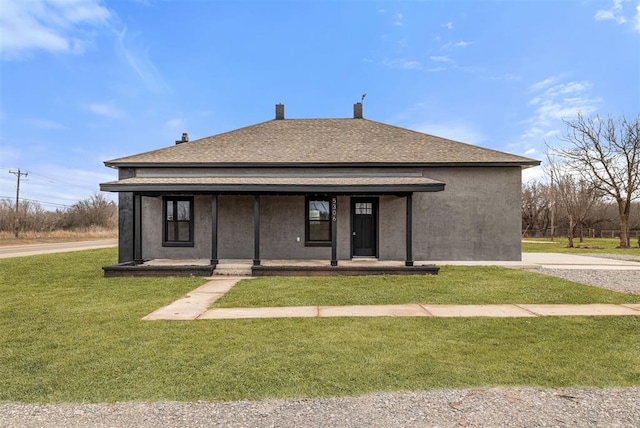 rear view of house featuring a porch and a yard