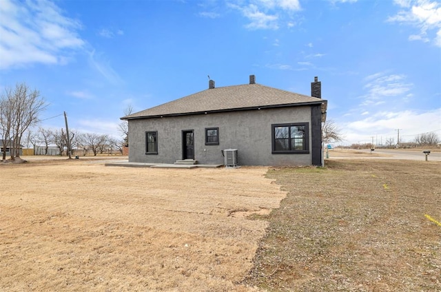 back of property featuring central AC