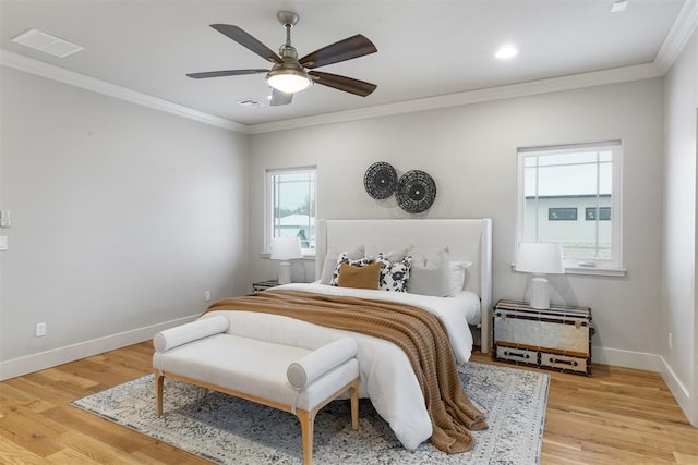 bedroom featuring ornamental molding, ceiling fan, and light hardwood / wood-style floors