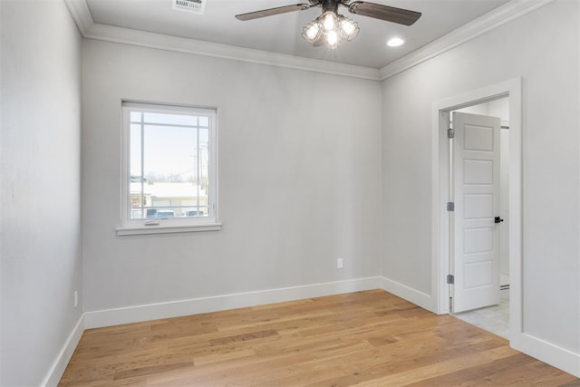 empty room featuring ornamental molding, light hardwood / wood-style floors, and ceiling fan