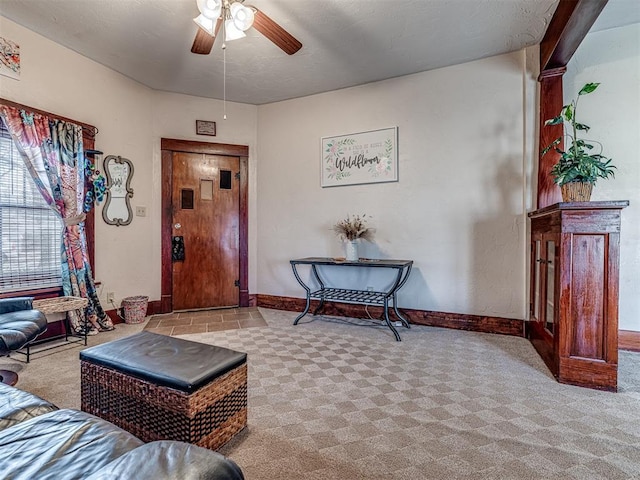 carpeted living room featuring ceiling fan