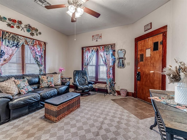 carpeted living room with a textured ceiling and ceiling fan