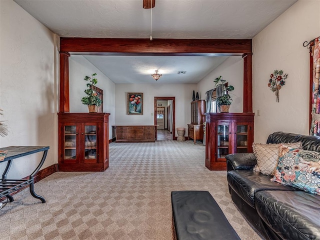 living room with light carpet and beam ceiling