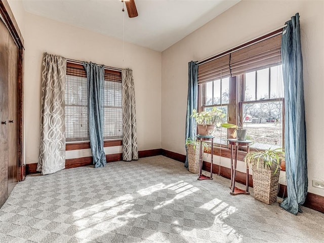 carpeted spare room with ceiling fan