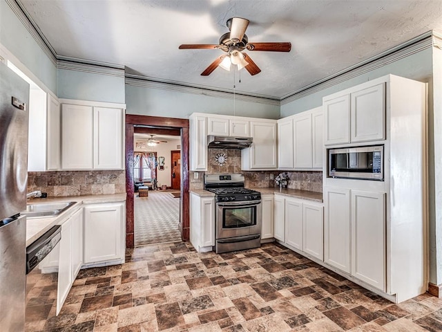 kitchen featuring stainless steel appliances, crown molding, and white cabinets