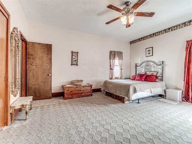 bedroom featuring light carpet and ceiling fan