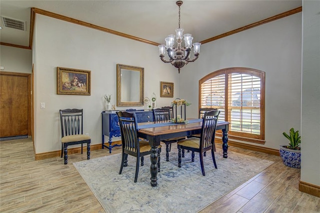 dining space featuring crown molding and light wood-type flooring