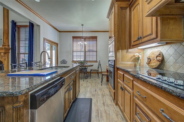 kitchen with sink, crown molding, appliances with stainless steel finishes, a center island with sink, and custom exhaust hood