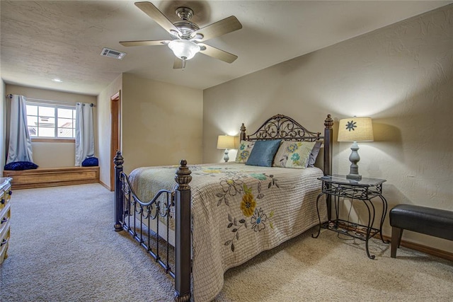 bedroom featuring ceiling fan and carpet