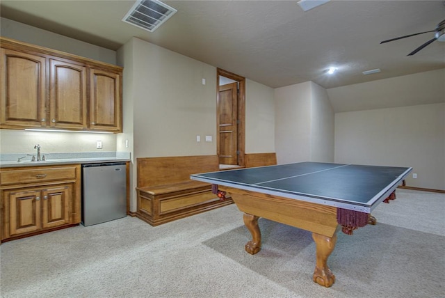 game room with ceiling fan, vaulted ceiling, light carpet, and indoor wet bar