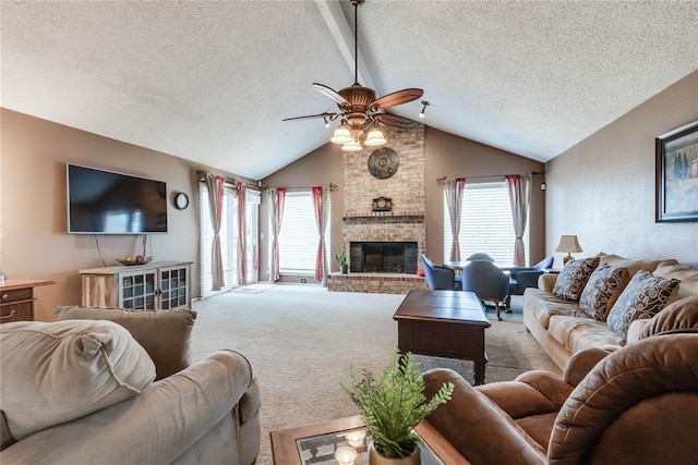 carpeted living room with ceiling fan, lofted ceiling, a brick fireplace, and a textured ceiling