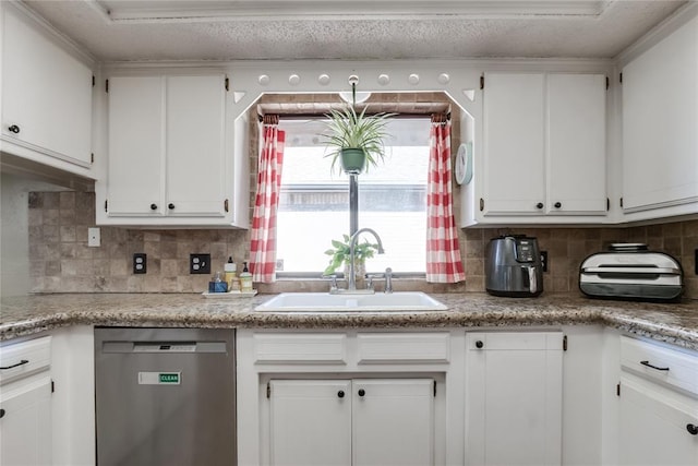 kitchen featuring dishwasher, sink, and white cabinets