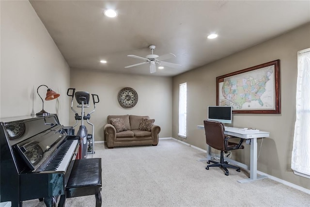 carpeted office space with plenty of natural light and ceiling fan