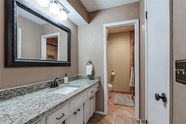 bathroom with vanity, toilet, and tile patterned flooring