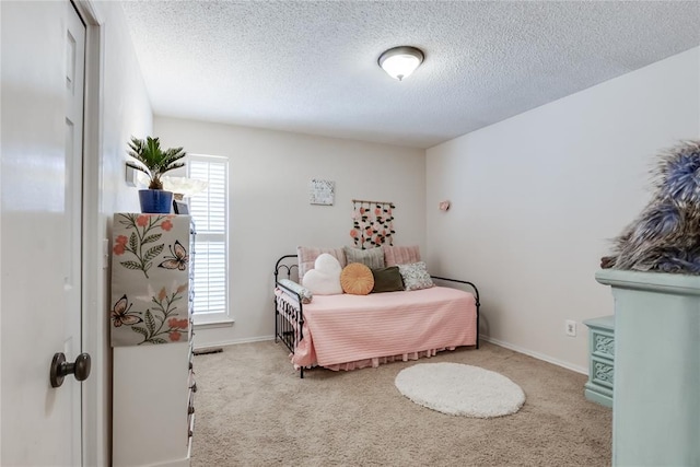 carpeted bedroom featuring a textured ceiling