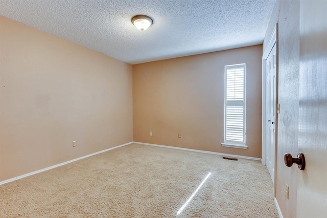 12909 Saint Christopher Dr, Oklahoma City, OK 73120 - empty room with carpet floors, a textured ceiling, and baseboards