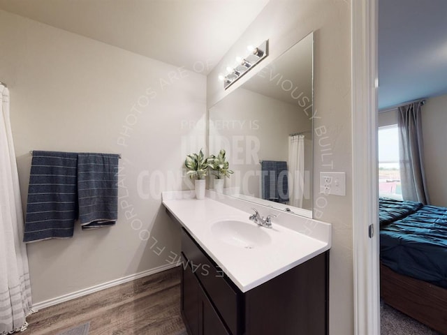 bathroom with vanity and hardwood / wood-style flooring