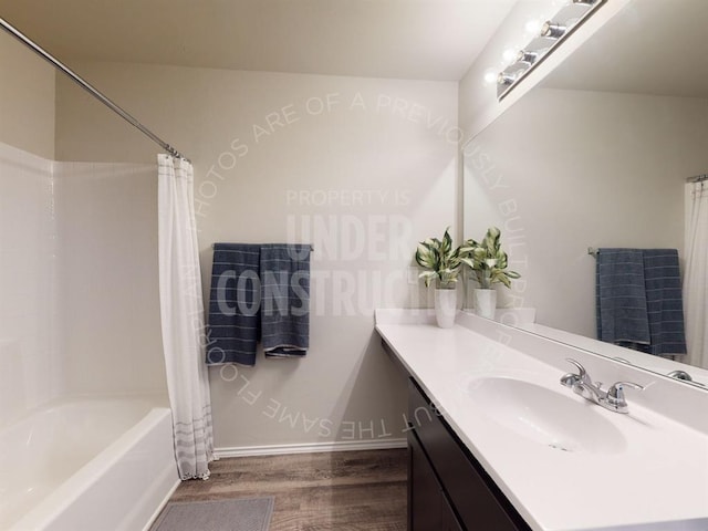 bathroom featuring wood-type flooring, shower / tub combo with curtain, and vanity