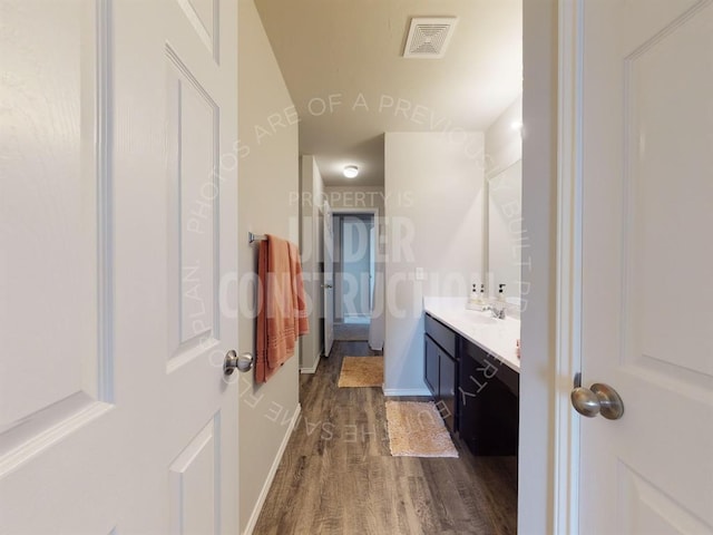 bathroom with vanity and hardwood / wood-style floors