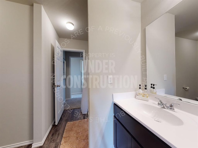 bathroom with hardwood / wood-style flooring and vanity