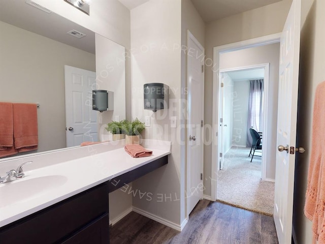 bathroom featuring wood-type flooring and vanity