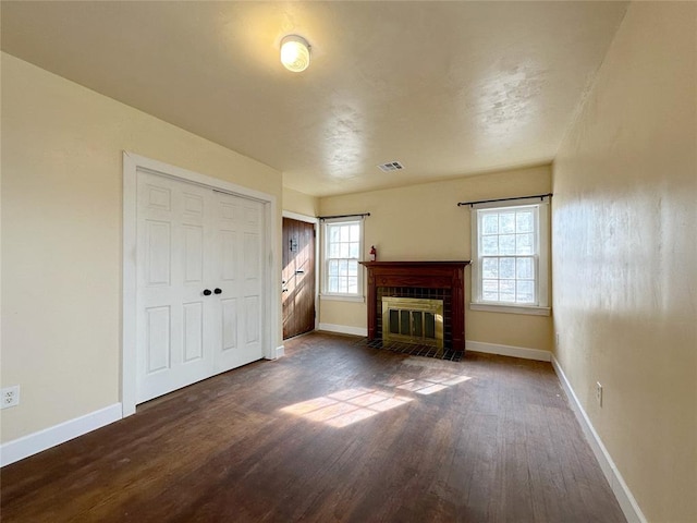 unfurnished living room with dark wood-type flooring