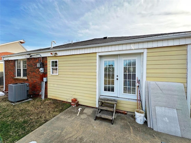 back of property featuring french doors, a patio, and central air condition unit