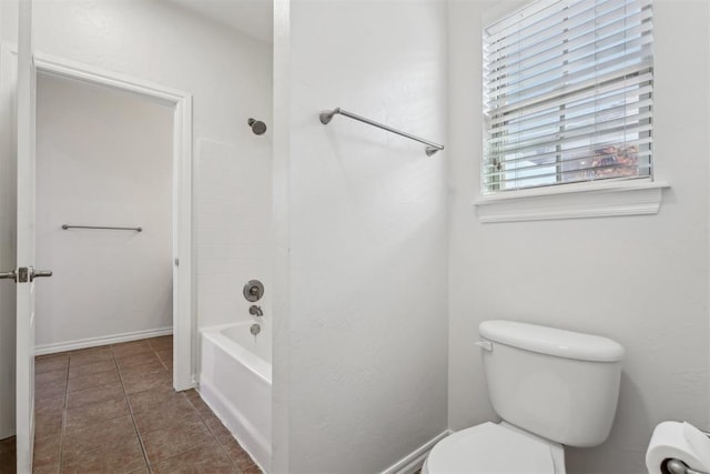 bathroom with shower / bathtub combination, tile patterned floors, and toilet