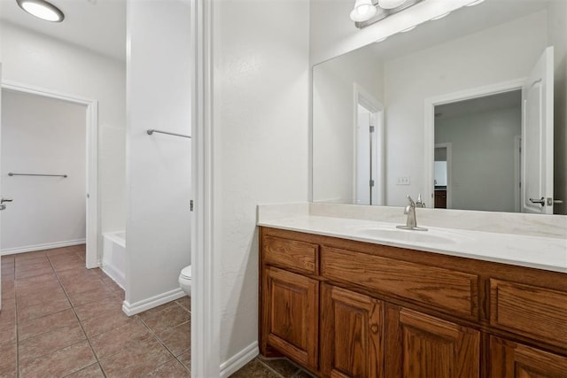 bathroom featuring vanity, toilet, and tile patterned flooring