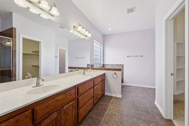 bathroom with tile patterned floors, vanity, and a shower with shower door