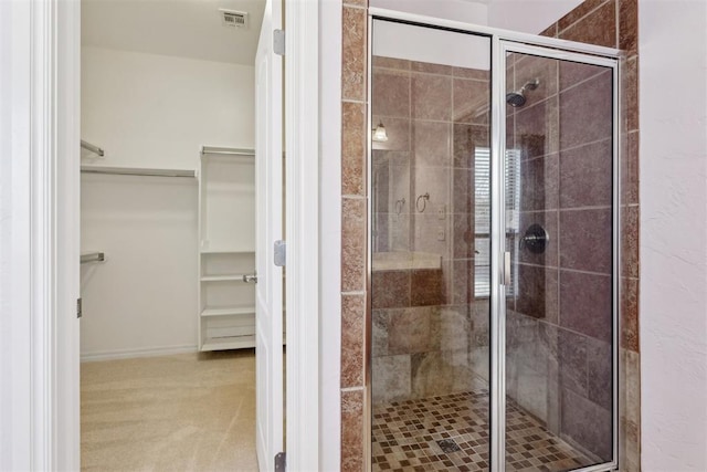 bathroom featuring a shower with shower door