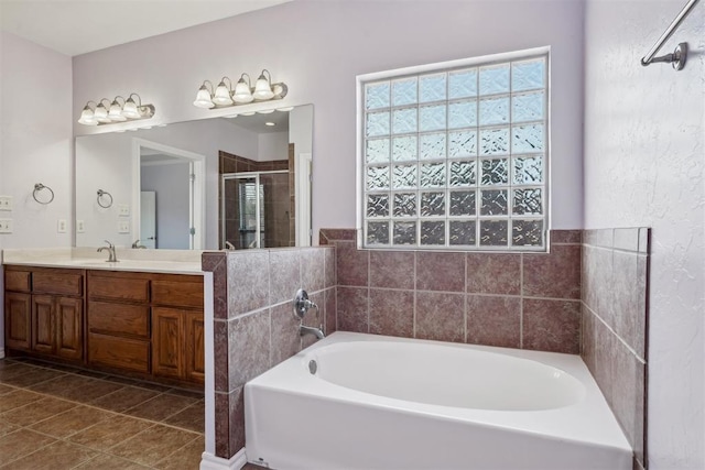 bathroom featuring vanity, separate shower and tub, and tile patterned floors